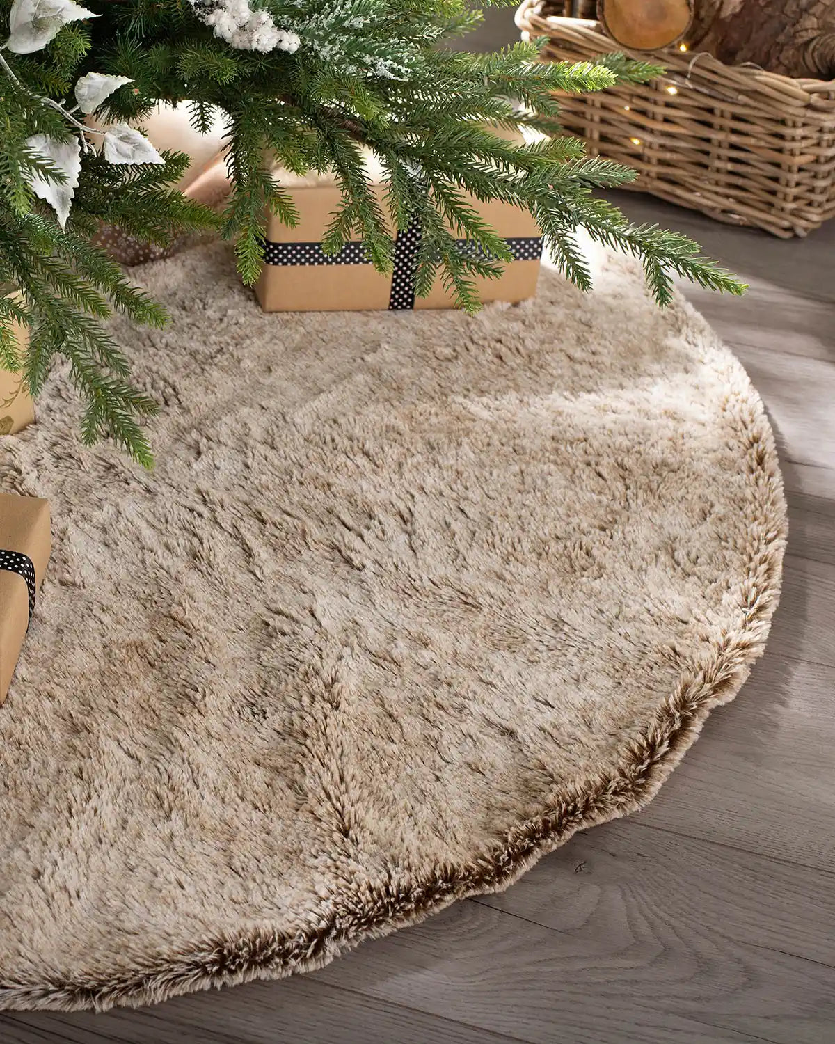 Two-tone brown faux fur tree skirt styled beneath a Christmas tree