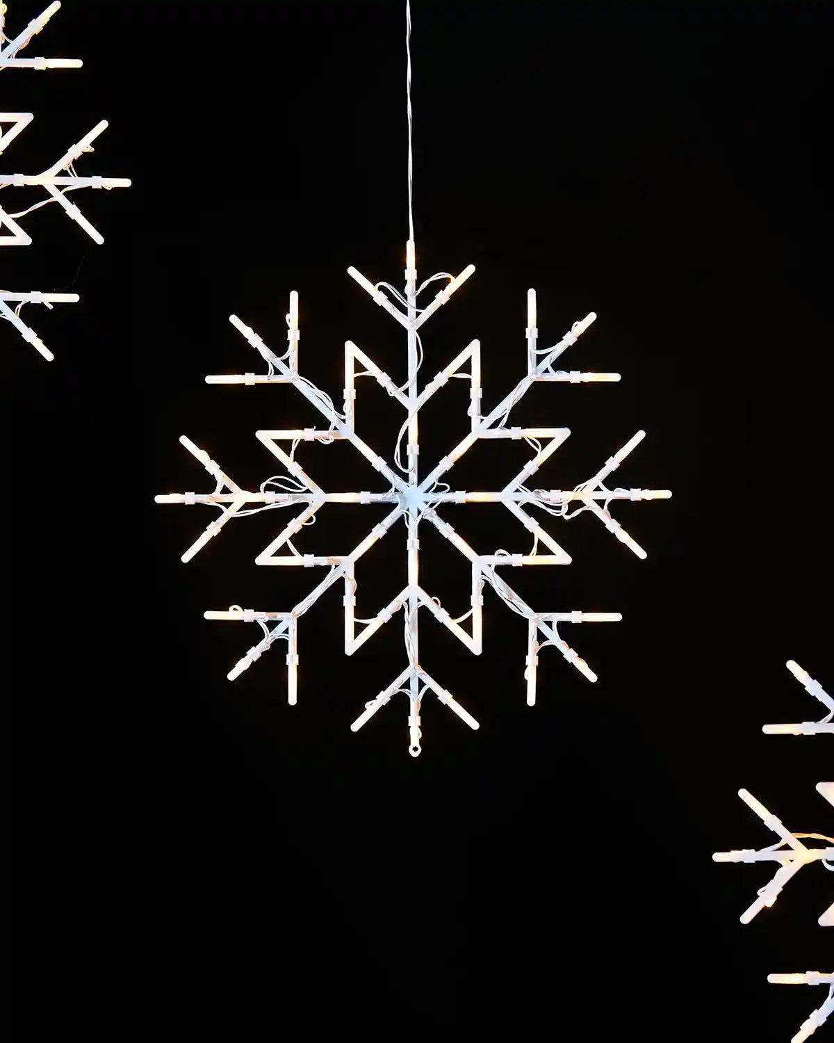 36 cm warm white snowflake silhouette decoration lit against a dark background