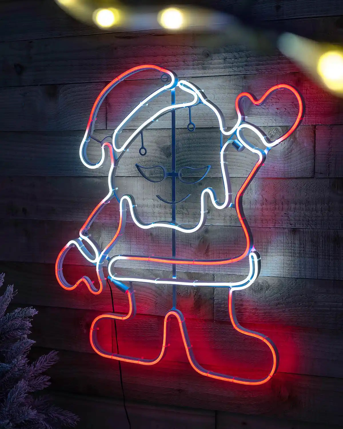 Waving Santa neon rope light decoration displayed on a wooden wall
