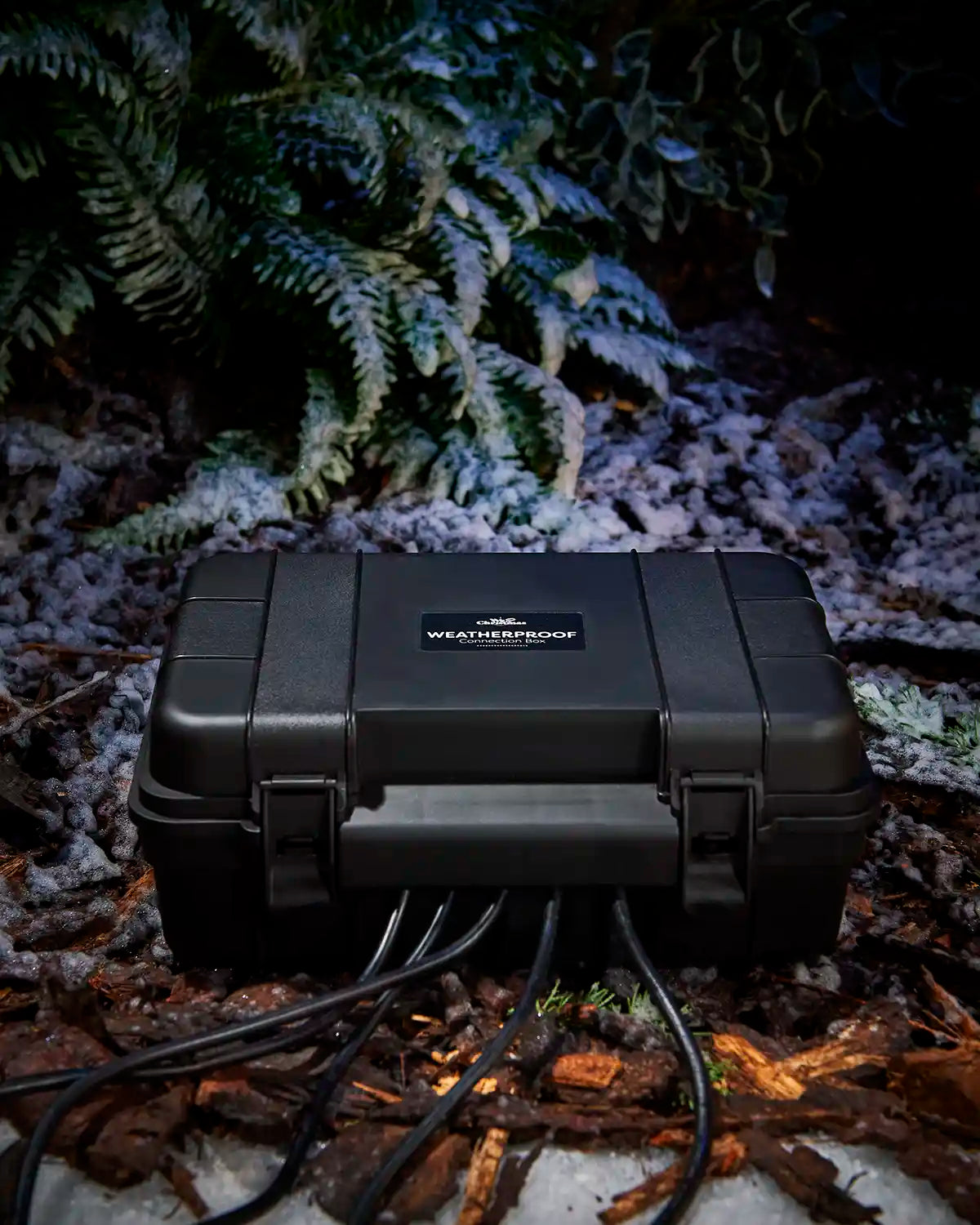Closed black weatherproof electrical box with cables running from the base.