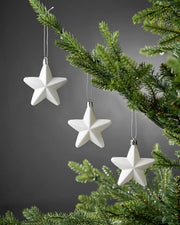 White 7cm hanging star decorations displayed on a Christmas tree.