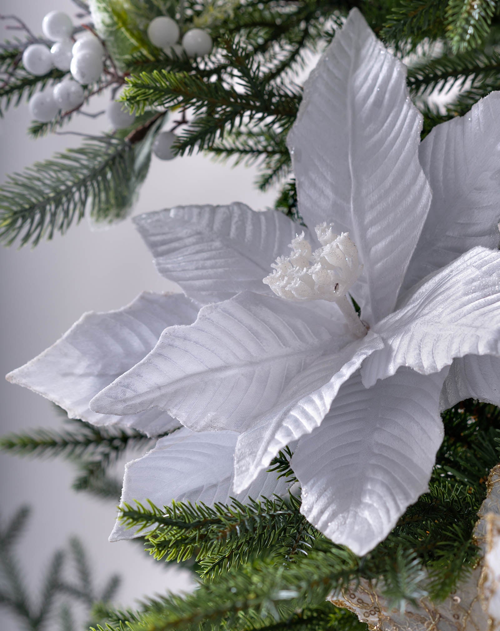 Close-up of white artificial poinsettia flower on Christmas tree