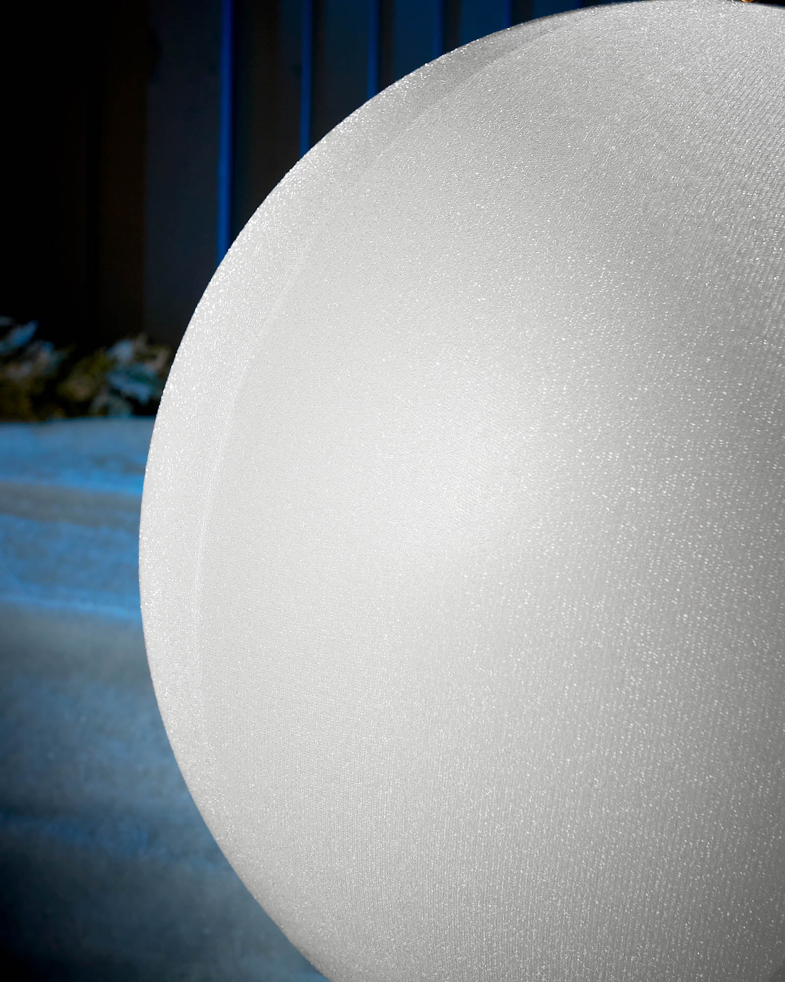 Detail close-up of the textured white tinsel surface on an inflatable Christmas bauble.
