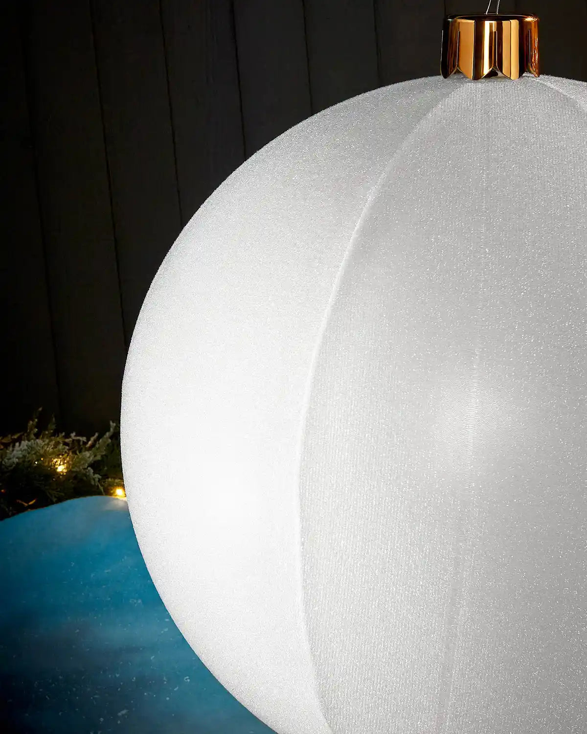 Detail close-up of the textured white tinsel surface on an inflatable Christmas bauble.