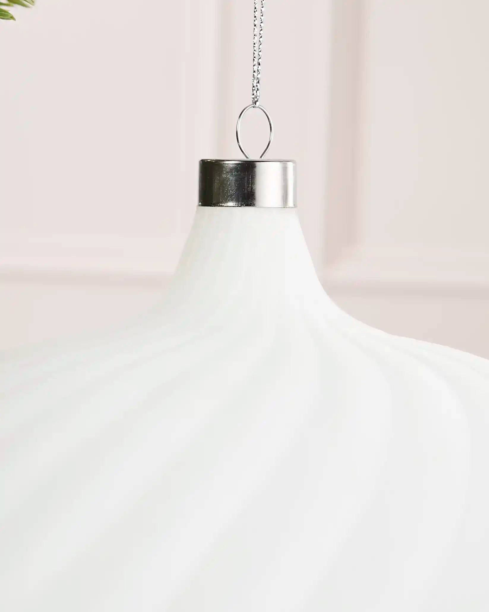 Close-up of a white 20 cm velvet spiral ribbed bauble showing the silver cap and top detail.