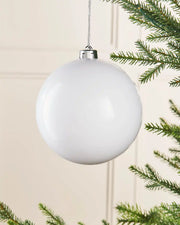 white gloss 15cm oversized bauble on a Christmas tree branch