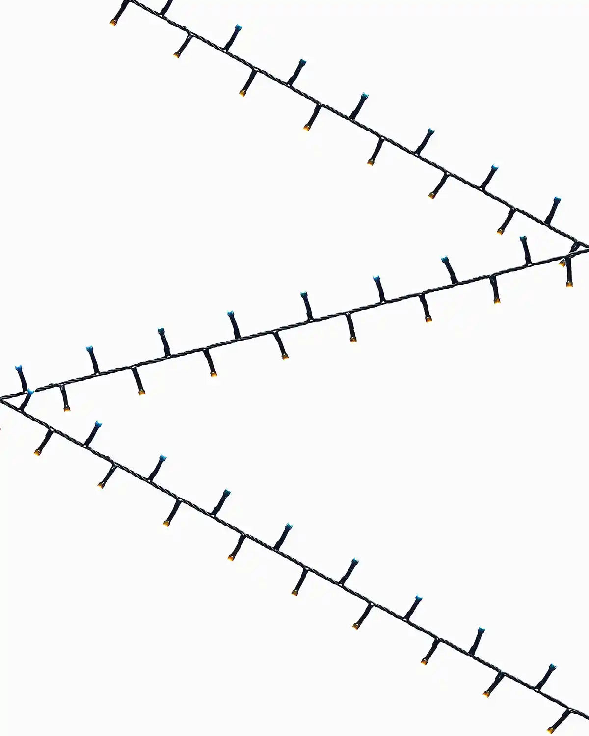 zig zag pattern of warm white and ice white fairly lights on a white background