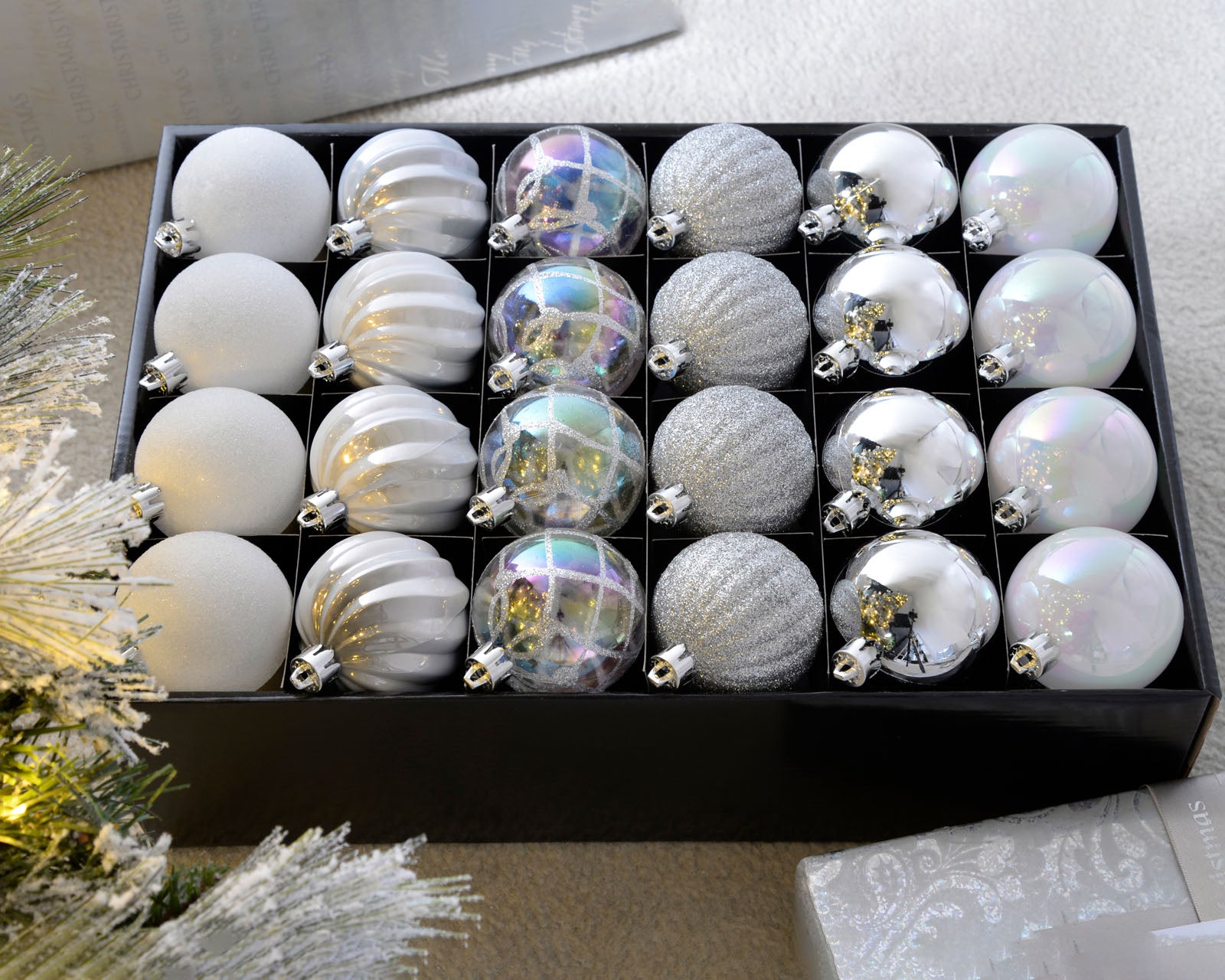 Set of 48 silver and white 6cm shatterproof baubles arranged in a storage box