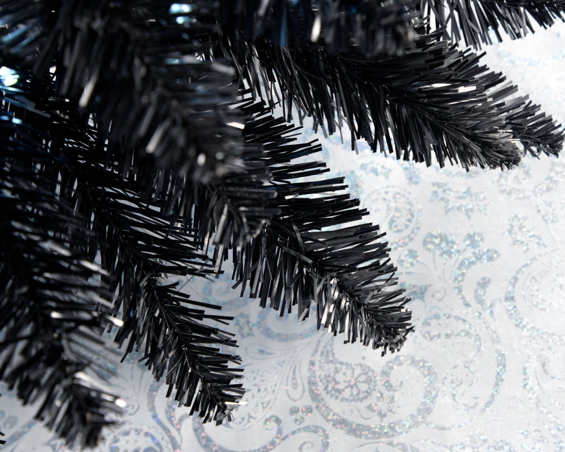 Slim pre-lit black pencil Christmas tree with 400 PE/PVC tips and 180 white LED lights, placed in a room corner—modern and elegant with a radiant glow, ideal for compact or stylish festive spaces.