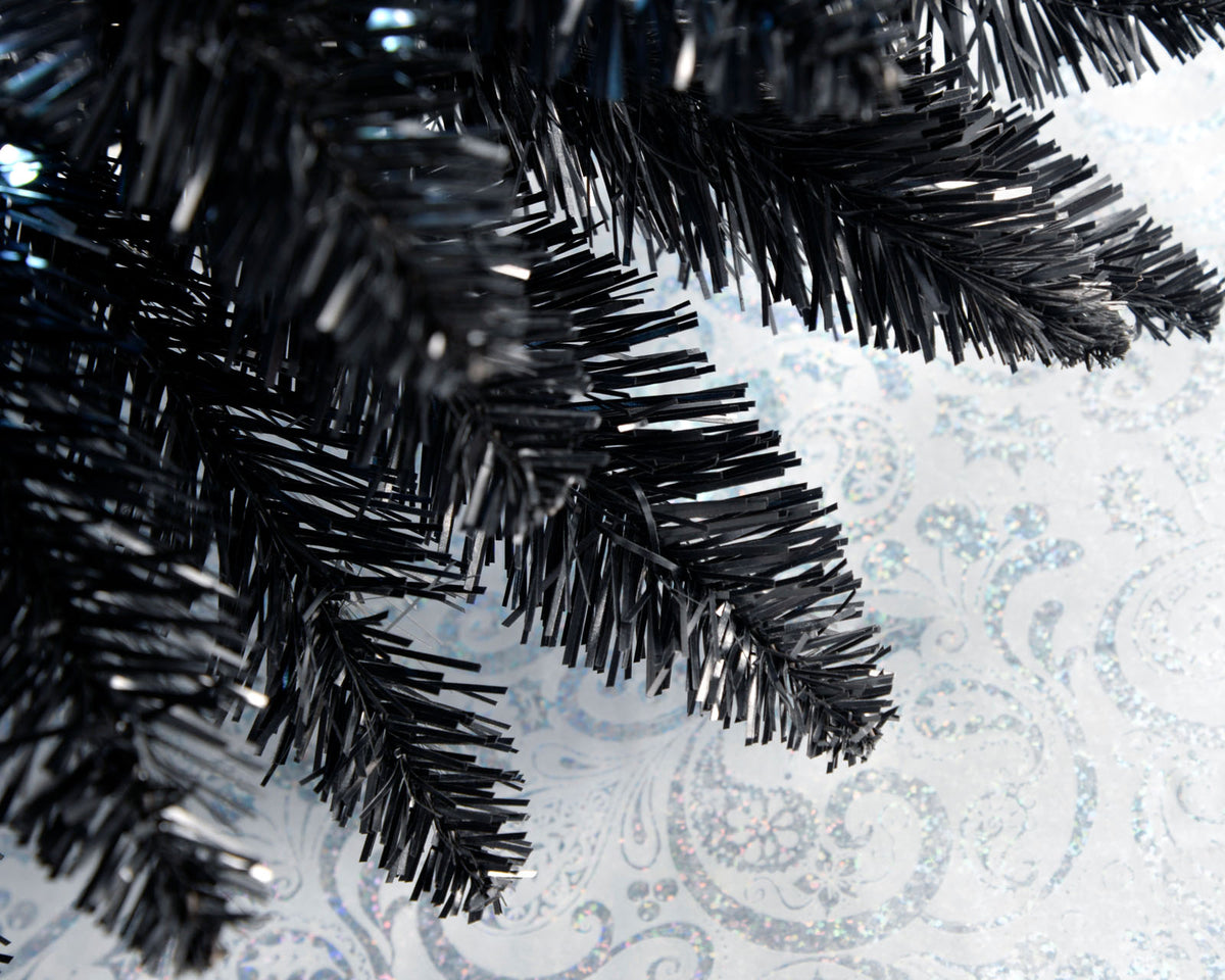 Slim pre-lit black pencil Christmas tree with 400 PE/PVC tips and 180 white LED lights, placed in a room corner—modern and elegant with a radiant glow, ideal for compact or stylish festive spaces.